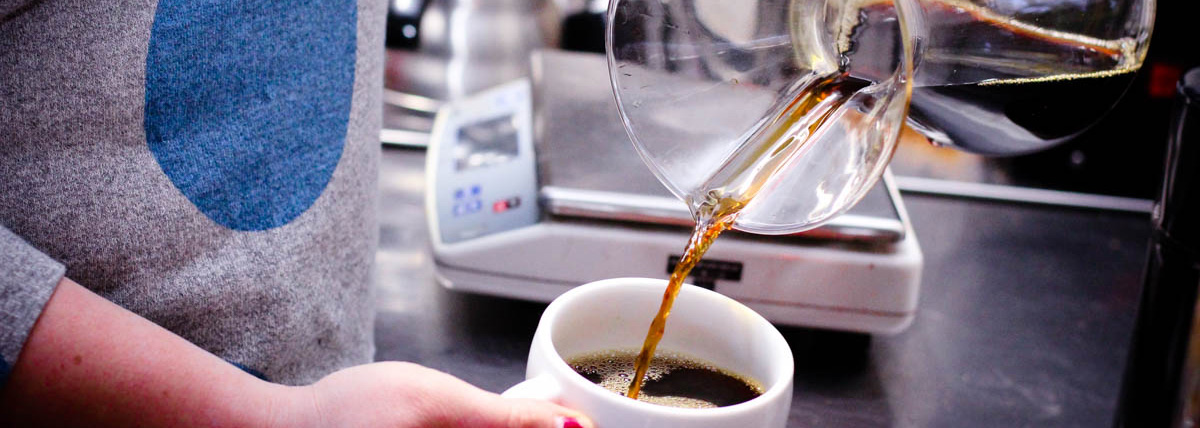 Coffee Cafe Barista Pouring Milk into Latte