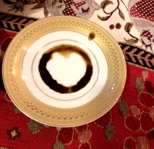 Saucer with coffee grounds, used for fortune telling.